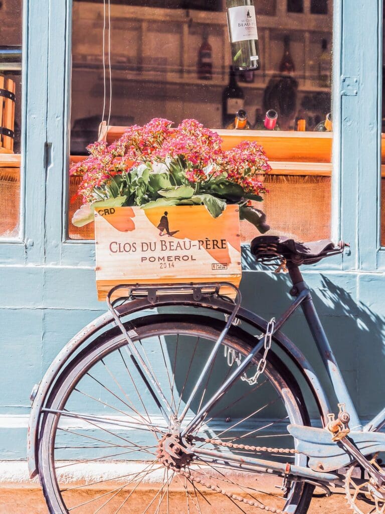 Close up of a bike basket filled with flowers, in a European street